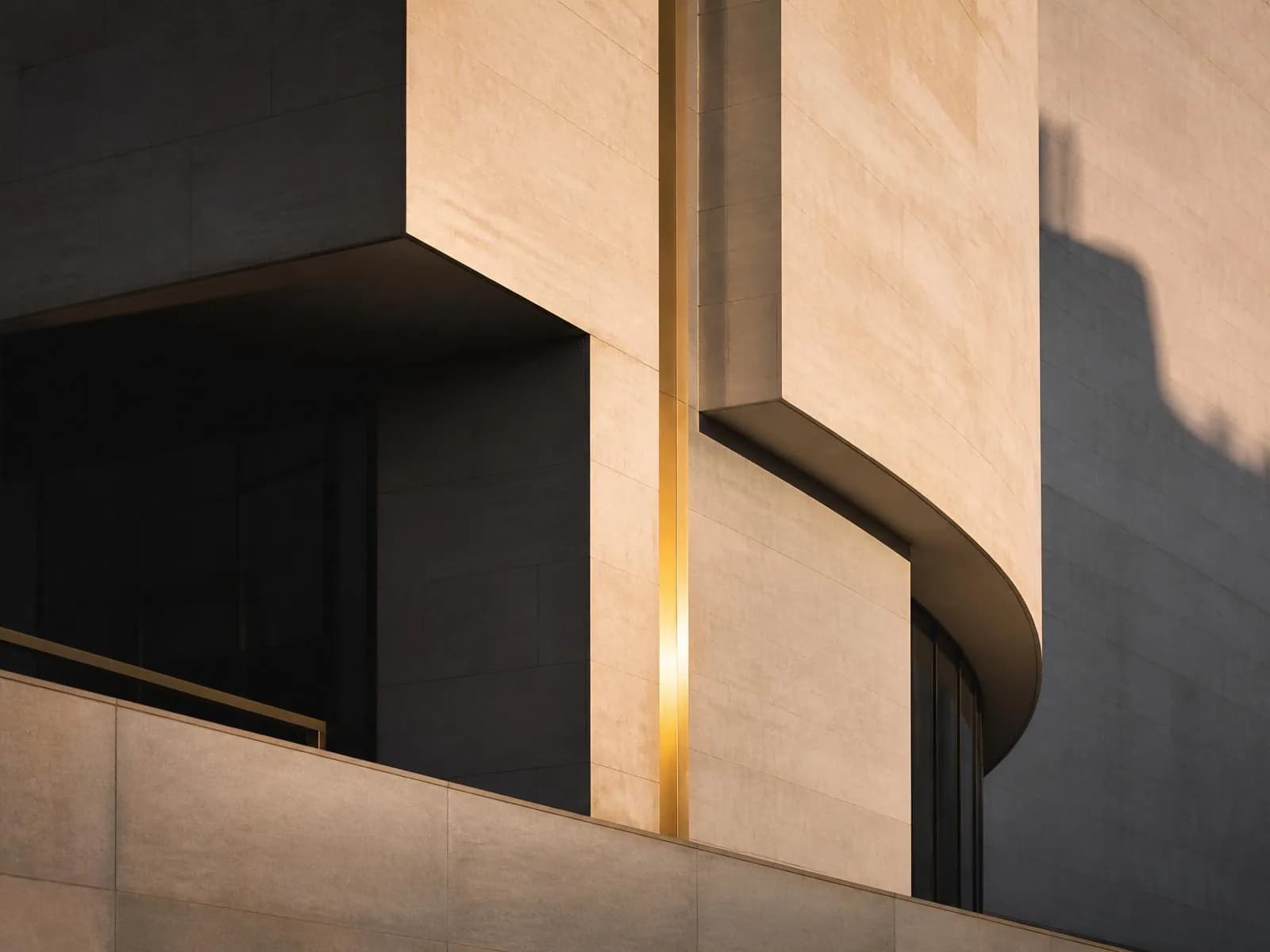 Sunlit sandstone architecture with a thin vertical line of gold light between curved walls